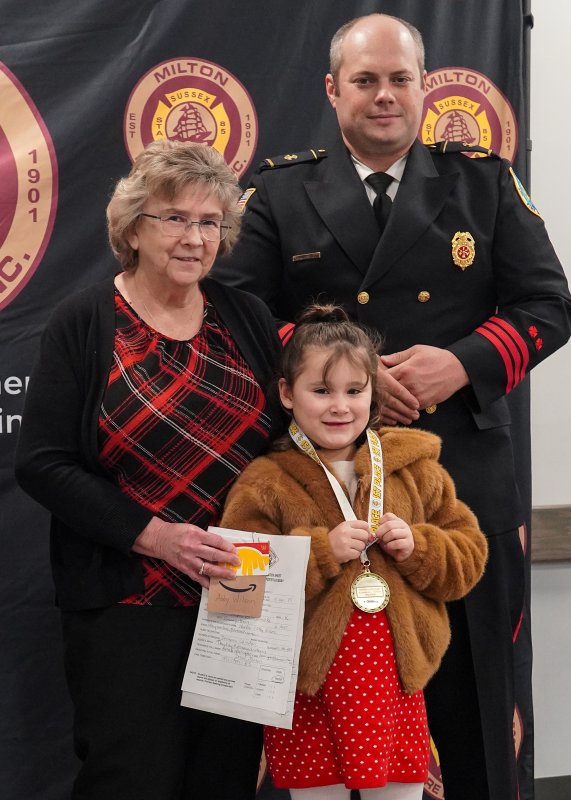 First-place kindergarten winner Abby Wilson is flanked by Mary Ann Argo and Bryan Reynolds.
